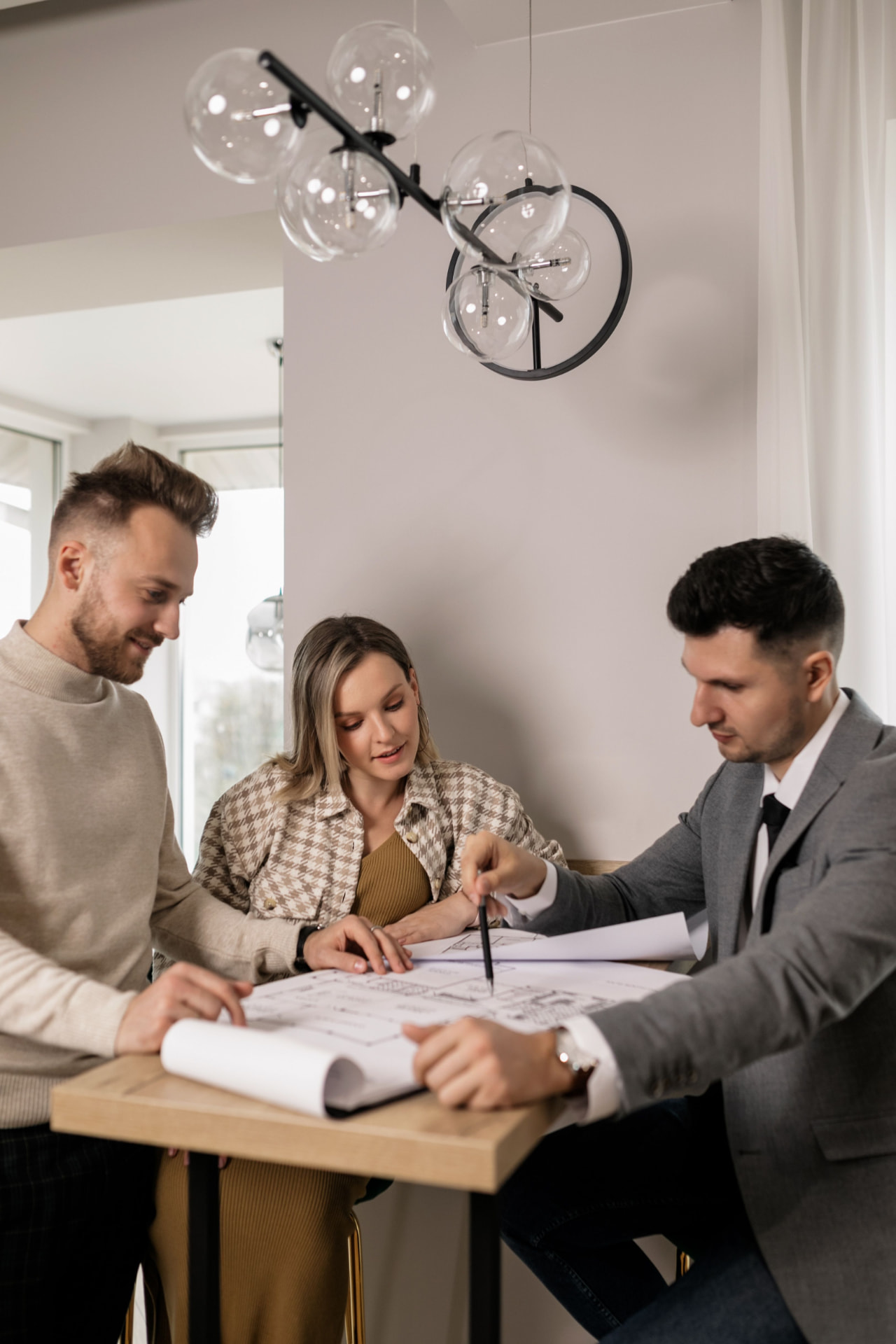 Deacan consultants reviewing a project plan with a client around a table